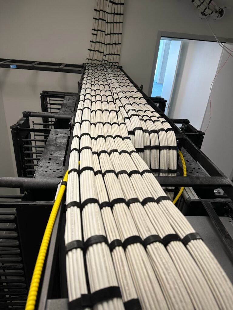 Bundled cabling running along an overhead cable tray